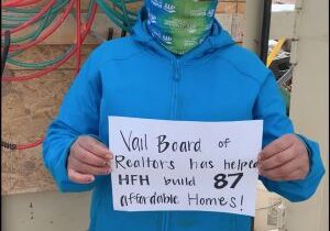 Habitat homeowner with sign thanking the VBRF