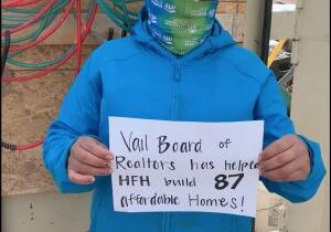 Habitat homeowner with sign thanking the VBRF