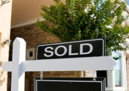Sold sign posted in front of a home